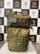 "Front view of military-style camouflage unisex backpack with tactical straps and USA flag patch"