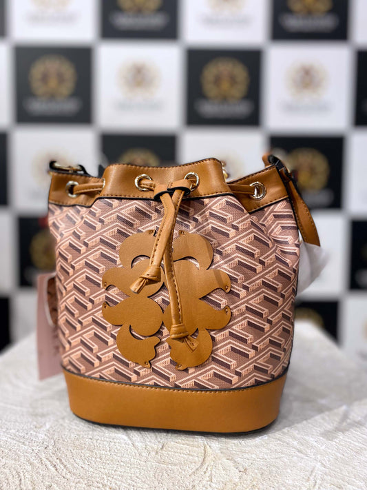 Front view of stylish bucket shoulder handbag with coffee brown geometric design

