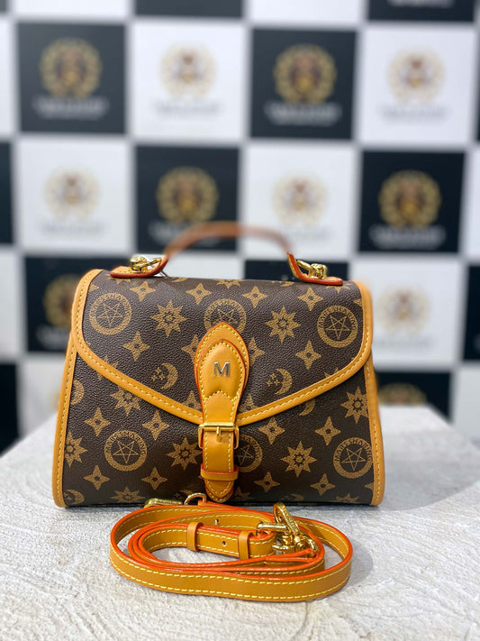 Front view of brown FOXER handbag with golden star and moon pattern