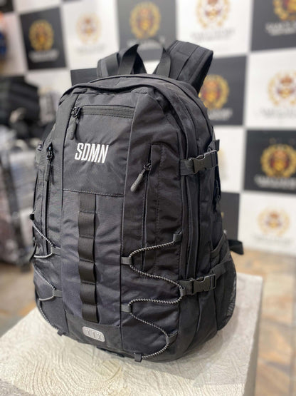 Front view of SDMN unisex black backpack with multi-zip pockets and modern style