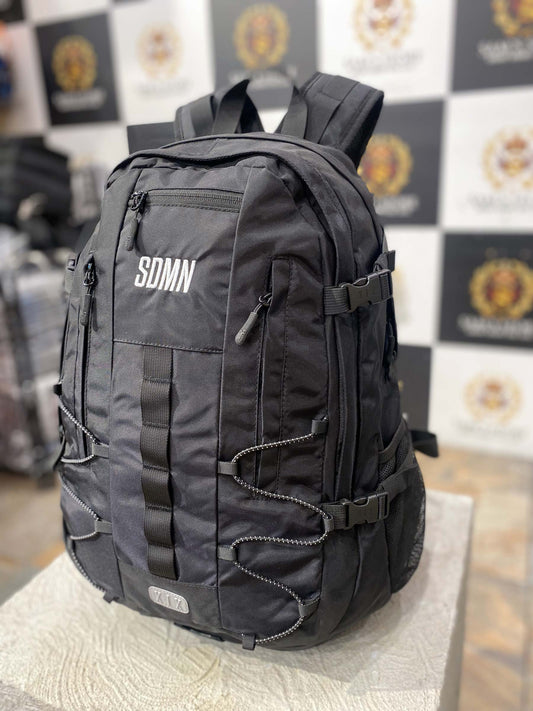 Front view of SDMN unisex black backpack with multi-zip pockets and modern style