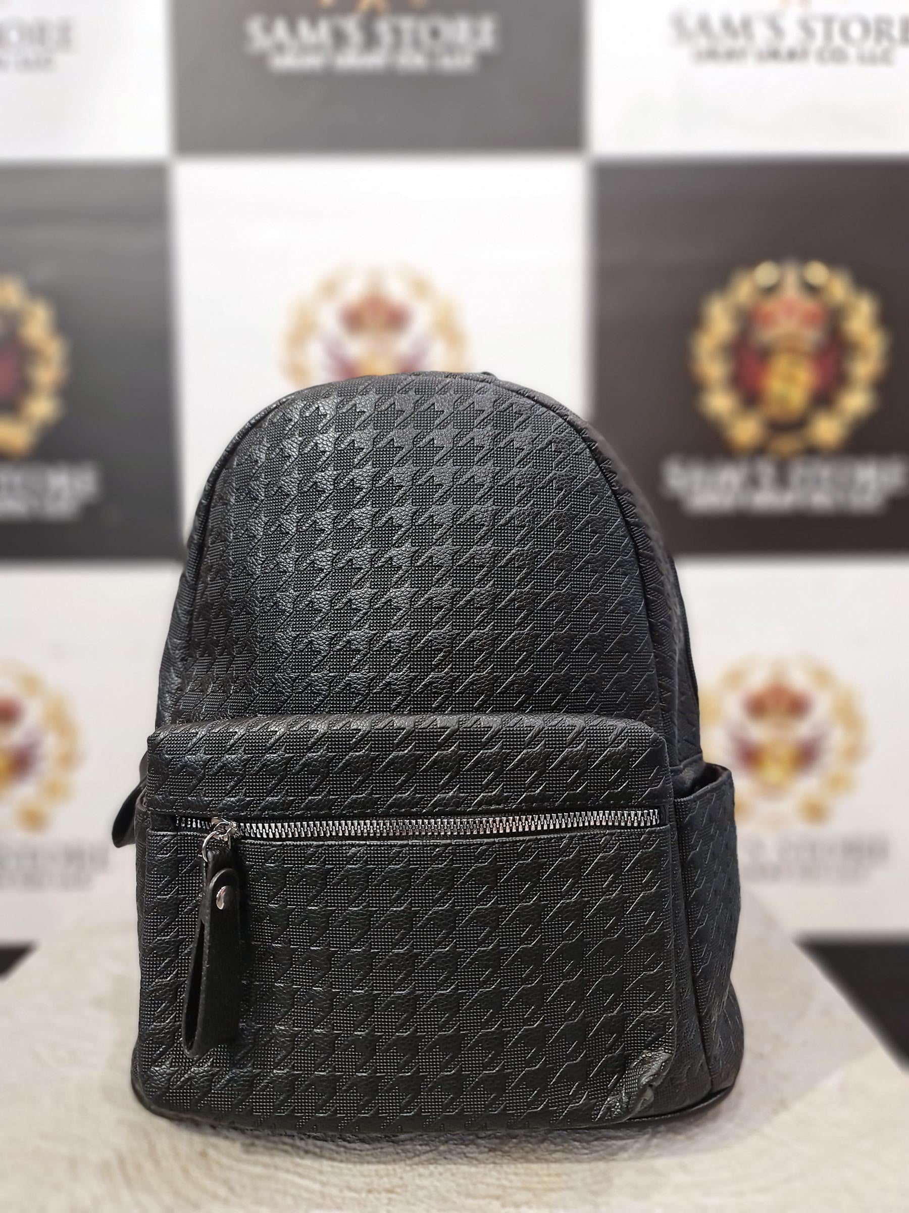 Small black faux leather ladies backpack with front zip and side pockets