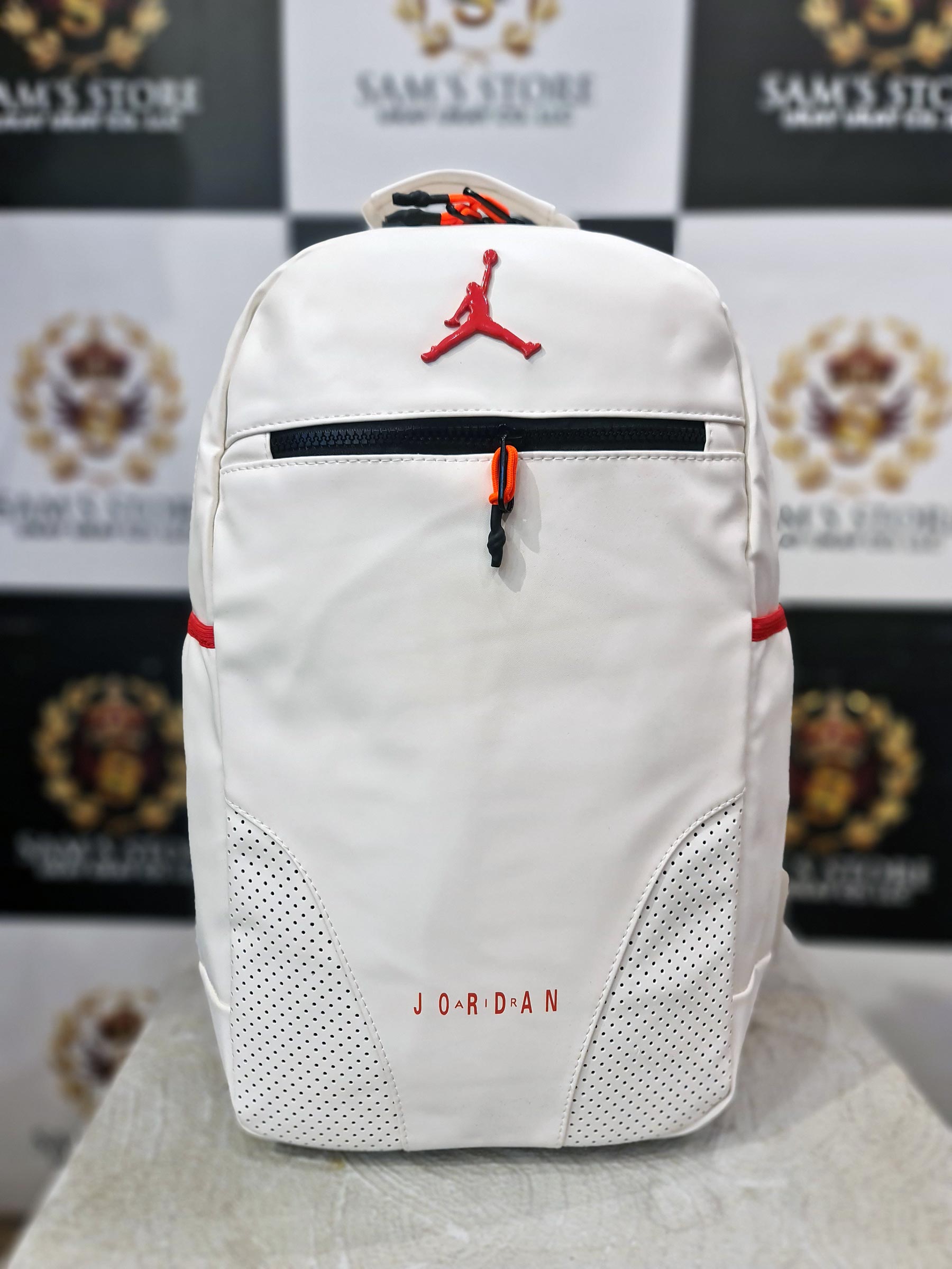 White Jordan-style backpack with red accents and dual zips