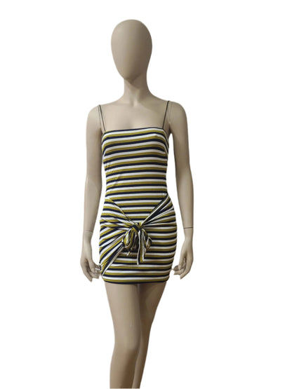 Front view of black, yellow, and white striped sleeveless mini dress with bow