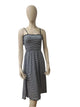 Front view of black and white striped sleeveless midi dress with ruffle detail