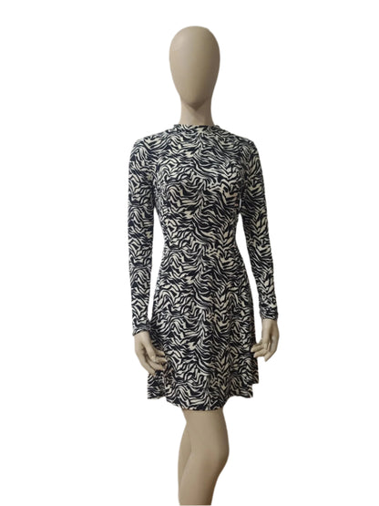 Front view of black and white zebra print long sleeve mini dress