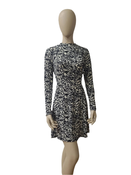 Front view of black and white zebra print long sleeve mini dress