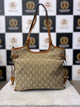 Front view of FOXER beige monogram hand bag with dual handles and tan leather accents